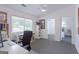 Bright home office featuring a ceiling fan, plush carpet, and a large window overlooking the front yard at 410 Golf View Dr, Peachtree City, GA 30269
