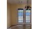 Cozy dining area features double doors and a stylish chandelier at 990 Hickory Bend Rd, Atlanta, GA 30349