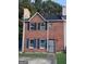 Charming two-story brick home with a well-maintained front yard and a secure metal gate at 990 Hickory Bend Rd, Atlanta, GA 30349