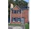 Charming two-story brick home with a well-maintained front yard and a secure metal gate at 990 Hickory Bend Rd, Atlanta, GA 30349