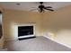 Bright living room featuring a ceiling fan, fireplace and tile flooring at 990 Hickory Bend Rd, Atlanta, GA 30349
