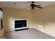 Bright living room featuring a ceiling fan, fireplace and tile flooring at 990 Hickory Bend Rd, Atlanta, GA 30349