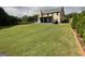 Expansive backyard with an extended back patio and manicured lawn at 1141 Norsworthy Ml, Hampton, GA 30228