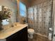 Standard bathroom with vanity, toilet, and shower featuring a decorative curtain and a neutral color scheme at 1141 Norsworthy Ml, Hampton, GA 30228