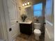 Cozy bathroom with a single vanity and decorative fixtures, showcasing a clean and functional space at 1141 Norsworthy Ml, Hampton, GA 30228
