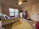 Well-lit bedroom with a ceiling fan, dresser, and inviting furnishings, creating a cozy and comfortable atmosphere at 1141 Norsworthy Ml, Hampton, GA 30228