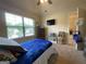 Inviting bedroom featuring a bright window, ceiling fan, and comfortable furnishings, providing a cozy and relaxing space at 1141 Norsworthy Ml, Hampton, GA 30228