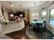 Eat-in dining area with decorative rug, bright windows, and modern chandelier near kitchen at 1141 Norsworthy Ml, Hampton, GA 30228