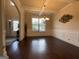 Elegant dining room with wainscoting, coffered ceiling, and hardwood floors at 1141 Norsworthy Ml, Hampton, GA 30228