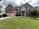 Beautiful two-story brick home with manicured lawn and attached two-car garage at 1141 Norsworthy Ml, Hampton, GA 30228