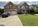 Charming two-story brick home with a well-manicured lawn and a two-car garage at 1141 Norsworthy Ml, Hampton, GA 30228