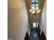 Bright foyer with high ceilings, chandelier, and a view of the front door at 1141 Norsworthy Ml, Hampton, GA 30228