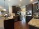 Well appointed kitchen featuring dark cabinetry, granite countertops, and stainless steel appliances at 1141 Norsworthy Ml, Hampton, GA 30228