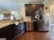 Spacious kitchen with stainless steel appliances, granite countertops, and dark wood cabinets at 1141 Norsworthy Ml, Hampton, GA 30228