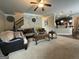 Open-concept living room featuring cozy seating, ceiling fan, and connection to the kitchen at 1141 Norsworthy Ml, Hampton, GA 30228