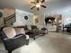 Open-concept living room featuring cozy seating, ceiling fan, and connection to the kitchen at 1141 Norsworthy Ml, Hampton, GA 30228