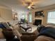 Cozy living room with fireplace, comfortable seating, and open layout to the dining area at 1141 Norsworthy Ml, Hampton, GA 30228