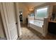 Bright bathroom with soaking tub, tile flooring, and natural light at 1141 Norsworthy Ml, Hampton, GA 30228
