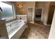 Bright bathroom with soaking tub, tile flooring, and natural light at 1141 Norsworthy Ml, Hampton, GA 30228