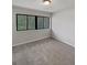 Cozy bedroom with soft carpet, a large window and a view of green trees at 1480 D Ne Pine Log Rd # D, Conyers, GA 30012
