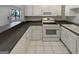 Well-lit kitchen featuring white cabinets, sleek countertops, and modern appliances at 1480 D Ne Pine Log Rd # D, Conyers, GA 30012