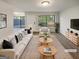 Bright, staged living room with large windows and a comfortable seating area with modern decor at 1480 D Ne Pine Log Rd # D, Conyers, GA 30012