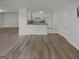 Open-concept living area featuring wood floors that flow into the kitchen at 1480 D Ne Pine Log Rd # D, Conyers, GA 30012