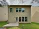 Backyard with lawn and concrete patio with the rear exterior of the home in view at 3712 Upland Dr, Mcdonough, GA 30253