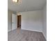 Bedroom featuring neutral walls and carpet with a ceiling light, and an open white paneled door at 3712 Upland Dr, Mcdonough, GA 30253