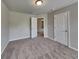 Bedroom featuring neutral walls and carpet with a ceiling light, and two white paneled doors at 3712 Upland Dr, Mcdonough, GA 30253