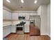 Modern kitchen featuring stainless steel appliances, granite countertops, and wooden floors at 3712 Upland Dr, Mcdonough, GA 30253
