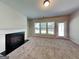 Cozy living room with a fireplace, large windows, and a neutral-toned carpet at 3712 Upland Dr, Mcdonough, GA 30253
