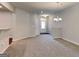 Spacious living area with a chandelier, open floor plan, and neutral-toned carpet at 3712 Upland Dr, Mcdonough, GA 30253