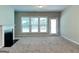 Bright and spacious living room with fireplace, large windows, and a doorway at 3712 Upland Dr, Mcdonough, GA 30253