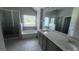 Bathroom featuring dual sinks, a soaking tub, and a separate glass-enclosed shower at 3750 Richmond Bnd, Lithonia, GA 30038