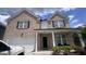 Charming two-story brick home with a two-car garage and a welcoming front porch at 3750 Richmond Bnd, Lithonia, GA 30038
