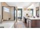 A spacious bathroom featuring double vanities, soaking tub and a separate shower with a glass door at 8110 Brewton Bnd, Cumming, GA 30028