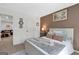 A bedroom featuring a queen bed with an accent wall, side table and decor at 8110 Brewton Bnd, Cumming, GA 30028