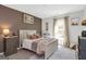 A nicely decorated bedroom with a queen sized bed, a view and nice lighting at 8110 Brewton Bnd, Cumming, GA 30028