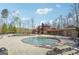 Beautiful community pool with ample seating and a luxurious clubhouse in the background at 8110 Brewton Bnd, Cumming, GA 30028