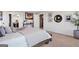 A cozy main bedroom with an ensuite bathroom is beautifully decorated with art and neutral colors at 8110 Brewton Bnd, Cumming, GA 30028
