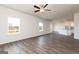 Open concept living room with wood-look flooring, leading into the kitchen and dining area at 288 Oliver Dr, Locust Grove, GA 30248