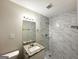 Bathroom featuring a granite vanity, tiled shower, and modern fixtures at 3403 Linda Dr, Lithia Springs, GA 30122