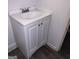 Bathroom vanity with a white basin sink, chrome faucet, and a white cabinet with panel doors at 5420 Herndon Blvd, Morrow, GA 30260