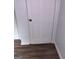 Bedroom with wood-look floors and a white paneled door providing access, complemented by neutral walls at 5420 Herndon Blvd, Morrow, GA 30260