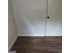 Corner of a bedroom with wood-look floors, neutral walls, and a white door, showing the room's layout at 5420 Herndon Blvd, Morrow, GA 30260