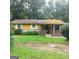 Charming single-story home with a welcoming front porch and a well-maintained lawn at 5420 Herndon Blvd, Morrow, GA 30260