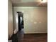 View of the living room with dark wood floors and a doorway leading into the kitchen at 5420 Herndon Blvd, Morrow, GA 30260