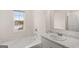 Bathroom with a soaking tub, a marble countertop, and a window at 1628 Palladian Dr, Lithonia, GA 30058