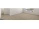 A bright, carpeted bedroom with a doorway and window providing natural light at 1628 Palladian Dr, Lithonia, GA 30058
